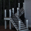 Location example shot of 6 x 6  Black Aluminum Solar Post Light with wooden post under it with stairs